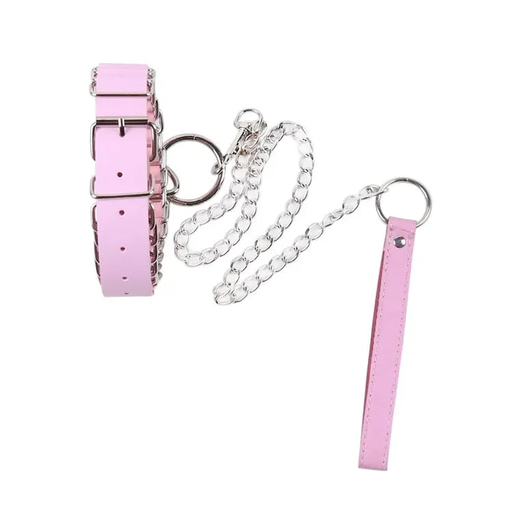 Pink leather-look pup play collar with silver buckle, O-ring, and attached chain leash