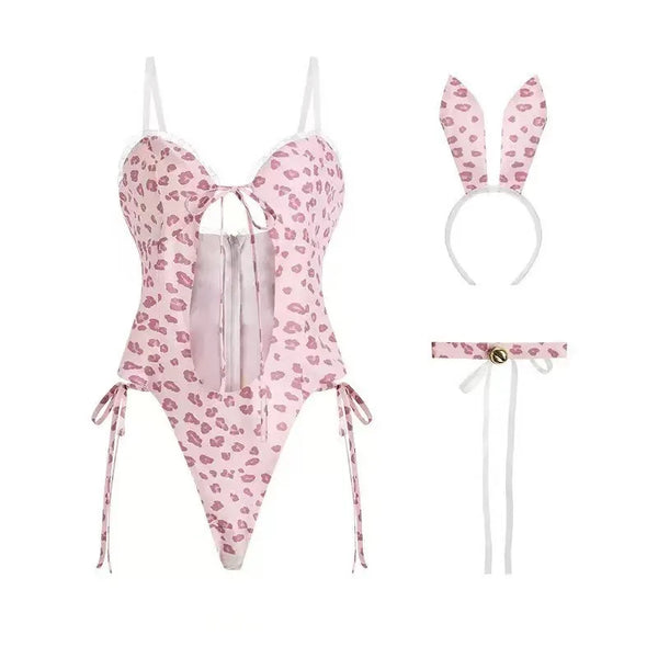 Flat lay of a pink lip-print bunny costume with corset-style bodysuit, ears, and collar