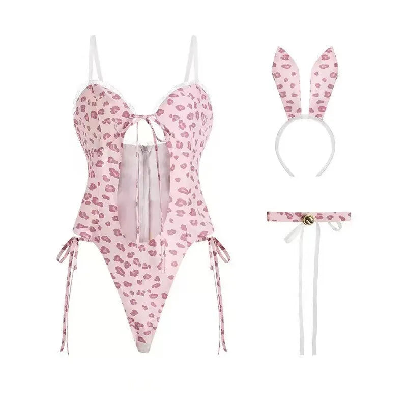 Flat lay of a pink lip-print bunny costume with corset-style bodysuit, ears, and collar