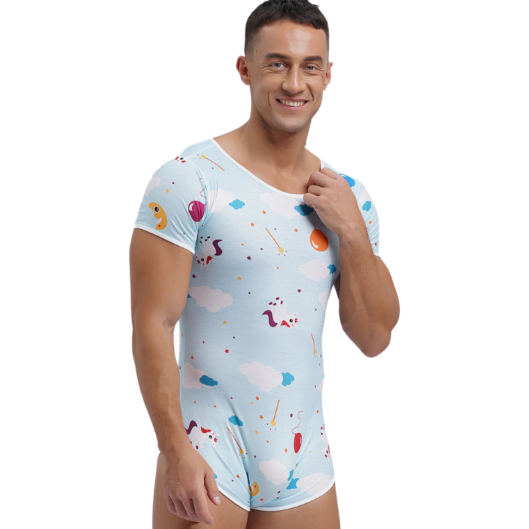 Smiling person models a light-blue short-sleeve unicorn-and-cloud printed onesie pajama