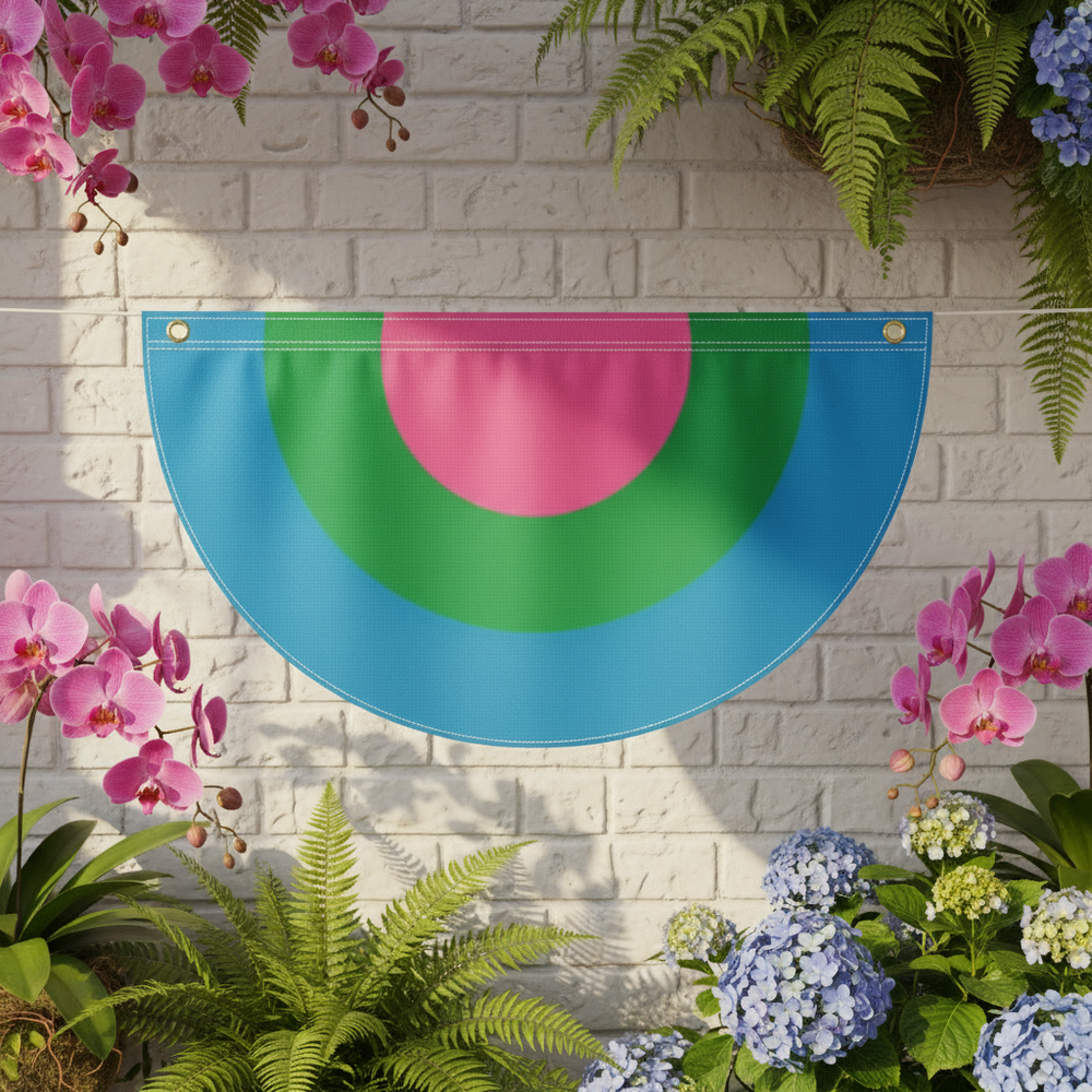 Polysexual pride bunting with pink and green semicircles on blue hangs against a brick wall