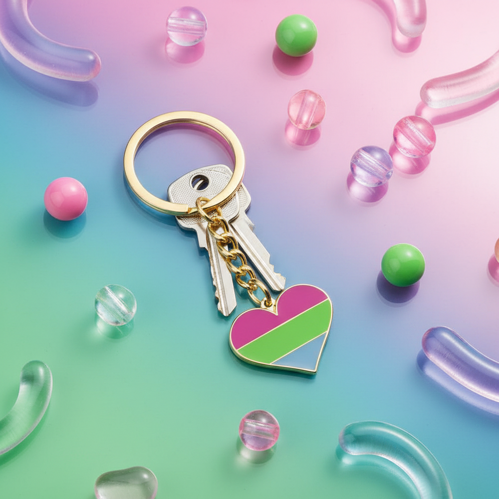 Polysexual pride heart keychain with gold ring and two silver keys on a colorful pastel background