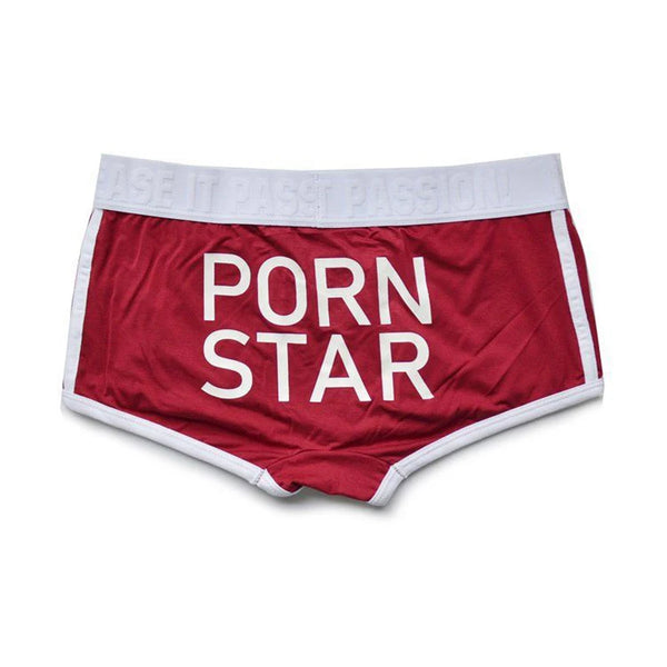 Front view of red briefs with white trim and large white “PORN STAR” lettering