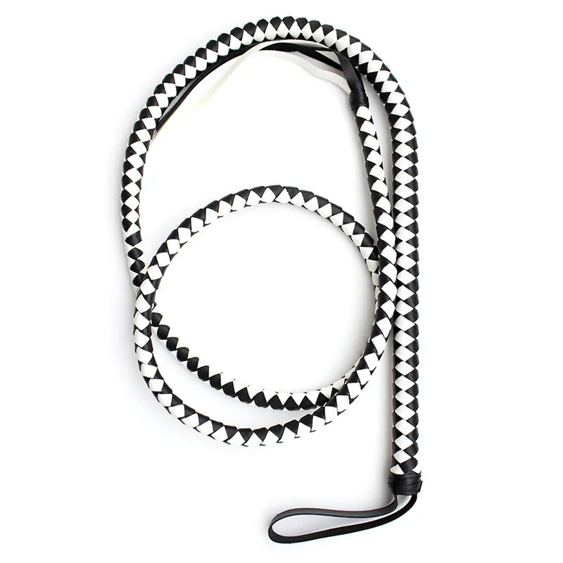 Coiled black-and-white braided bullwhip with a black wrist strap on a white background