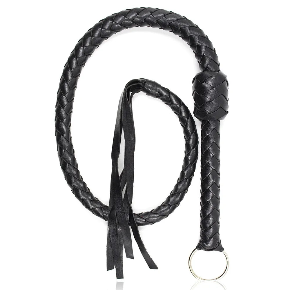 Black braided leather flogger coiled on a white background, with wrist strap and metal ring