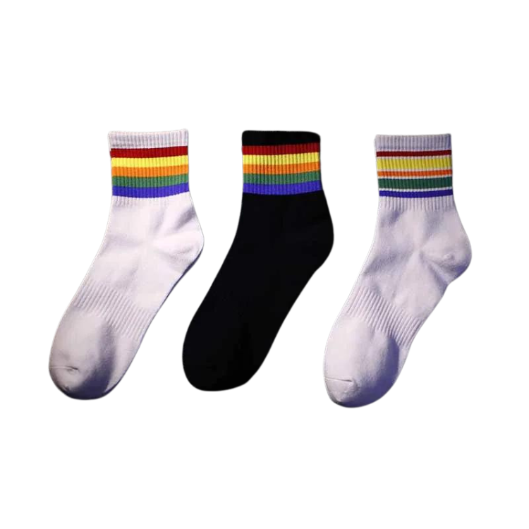 Three ankle socks, two white and one black, with rainbow-striped cuffs on a white background