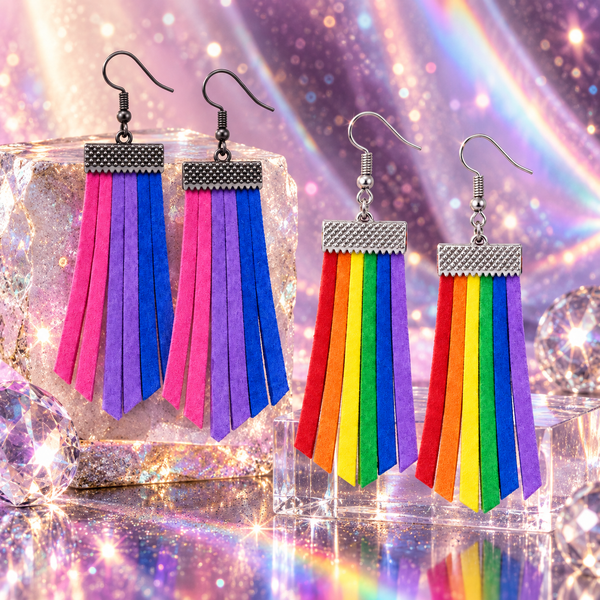 Four rainbow tassel earrings with textured metal caps, displayed on clear acrylic blocks