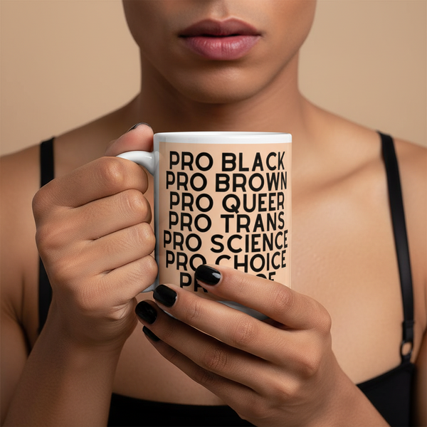 Person holding white printed ceramic mug, held in both hands; cheeky mug with “Pro Hoe” design