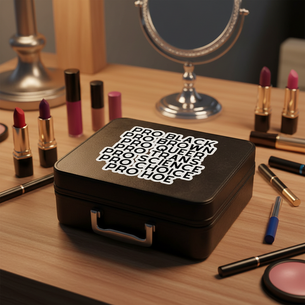 Black makeup case with bold white text on a chic vanity, surrounded by lipstick, brushes, and mirror
