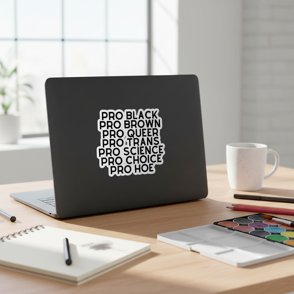 Black laptop displaying a stacked white sticker reading “PRO BLACK” through “PRO HOE”