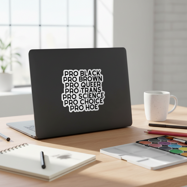 Black laptop displaying a stacked white sticker reading “PRO BLACK” through “PRO HOE”
