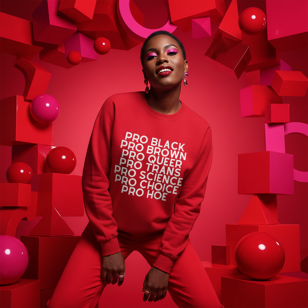 Pro Hoe Unisex Sweatshirt in red with bold white "Pro Hoe" text, rocked by a smiling person against a bright red backdrop
