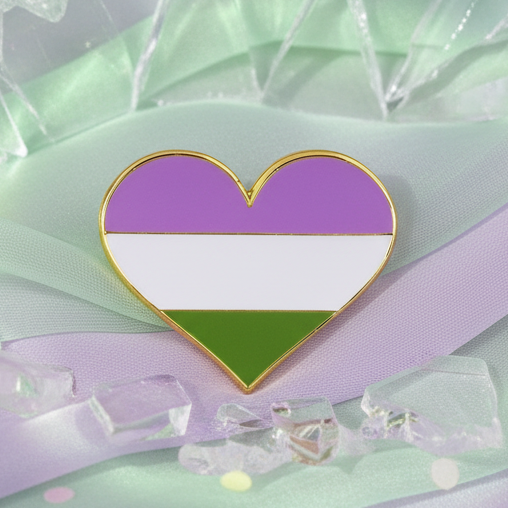 Close-up of a genderqueer pride heart enamel pin with purple, white, and green stripes