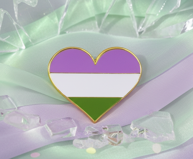 Genderqueer Pride Heart Enamel Pin with lavender, white, and green stripes outlined in gold, resting on mint and lavender fabric, surrounded by clear acrylic gems. A vibrant symbol of empowerment and pride.
