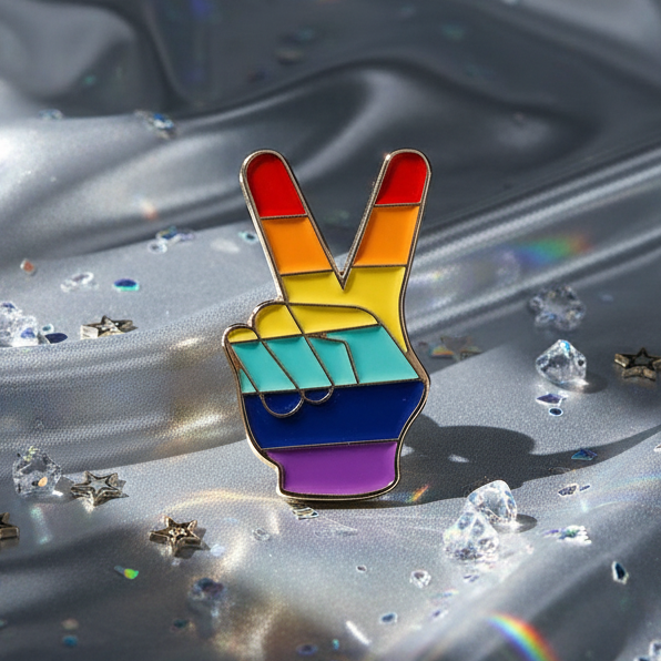 LGBT V Sign Pride Enamel Pin featuring a rainbow-striped peace sign hand, symbolizing LGBTQ+ love and pride, set on sparkling silvery fabric with star confetti, embodying bold queer energy and self-expression.