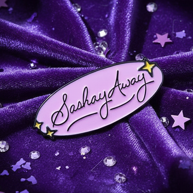 Sashay Away Enamel Pin on purple velvet, featuring pastel purple with Sashay Away in black script. Accented by yellow stars, rhinestones, and star confetti, embodying fierce LGBTQIA+ pride and self-expression.