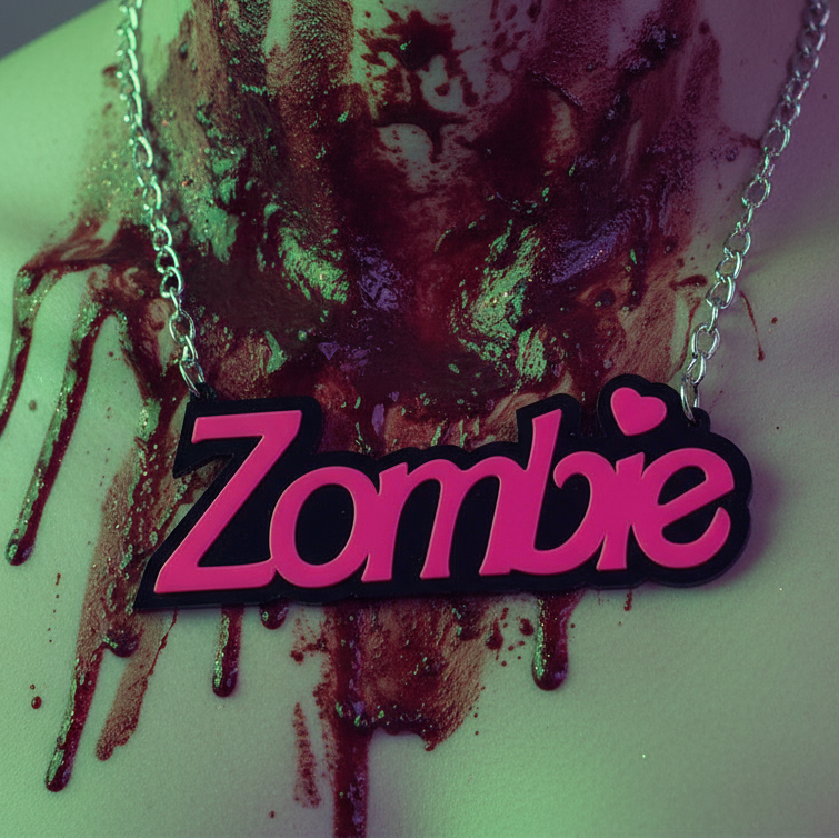 Close-up of the Zombie Acrylic Statement Chain Necklace with bold pink letters on a silver chain, dripping with dark red liquid. Captures a fierce, prideful self-expression with a horror-themed twist.