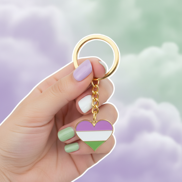 Genderqueer pride heart keychain with purple, white, and green enamel charm, held by a hand