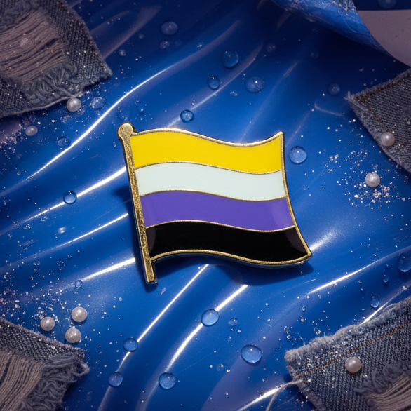 Non-Binary Flag Enamel Pin, showcasing vibrant pride stripes, lies on a glistening blue background with water droplets and denim, embodying LGBTQIA+ empowerment and self-expression.