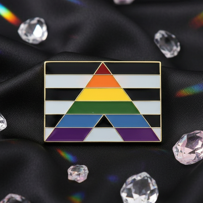 Straight Ally Enamel Pin on black satin, featuring black-and-white stripes with a central rainbow triangle. Surrounded by clear and pale pink gems, this pin symbolizes pride, empowerment, and self-expression.