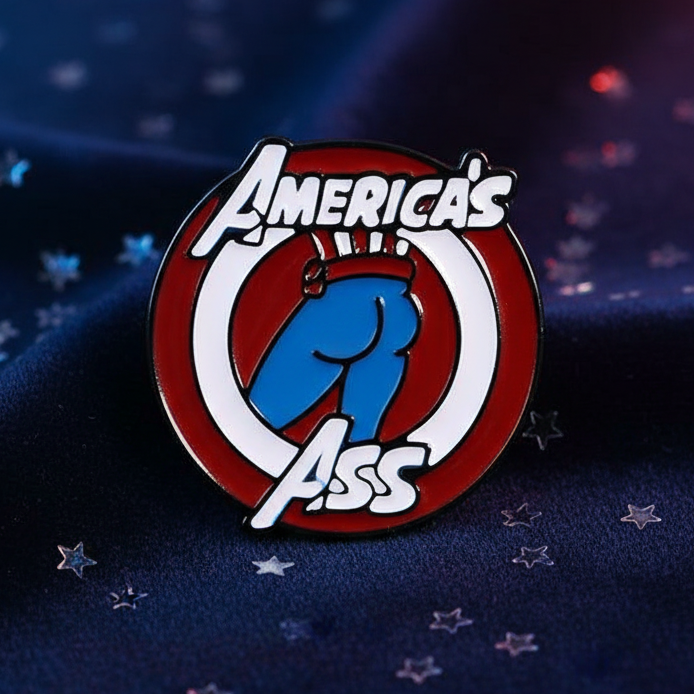 America's Ass Enamel Pin featuring a cartoon blue butt on red and white circles, symbolizing fierce queer pride and self-expression. Perfect for showcasing LGBTQIA+ visibility with bold, joyful energy.