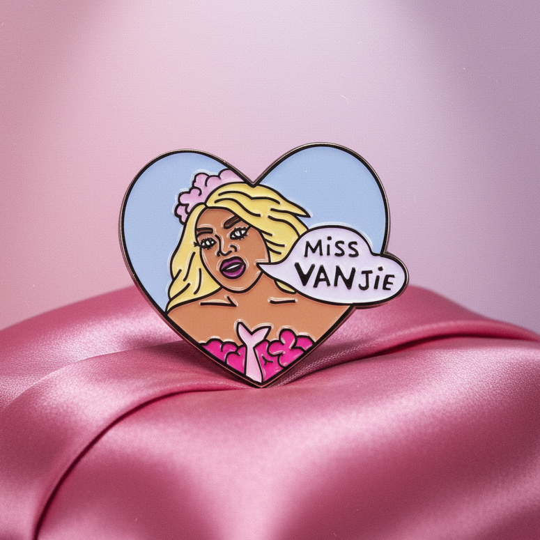 Miss Vanjie enamel pin with a heart-shaped drag queen illustration and speech bubble on pink satin