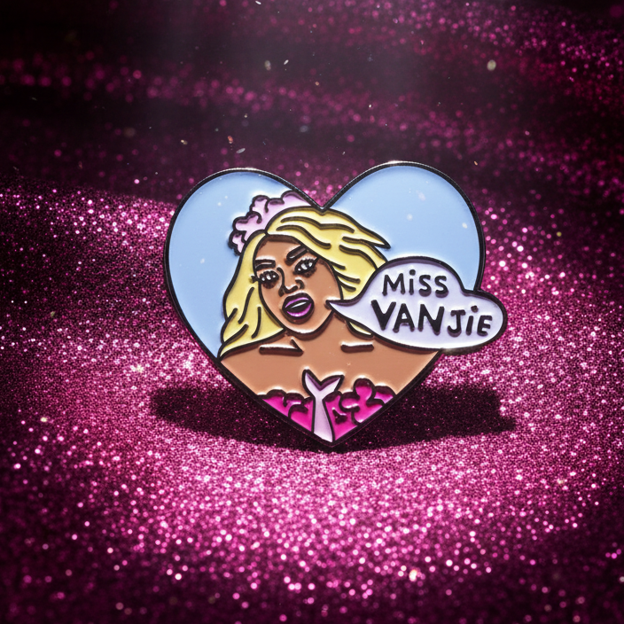 Miss Vanjie enamel pin with a blonde portrait and “MISS VANJIE” text in a blue heart