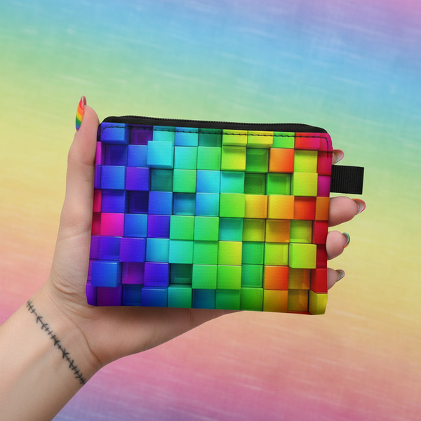Hand holding a rainbow woven coin purse with a black zipper