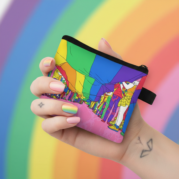 Hand holding a rainbow-striped change purse with illustrated figures and a black zipper