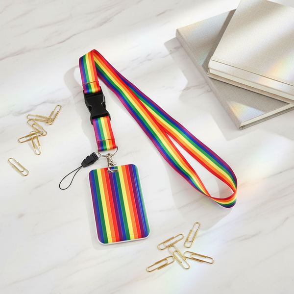 Rainbow Pride lanyard with matching rectangular ID card holder, shown flat on a marble surface