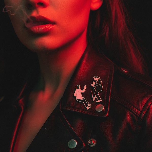 Pulp Fiction enamel pin showing two dancing figures on a black leather jacket