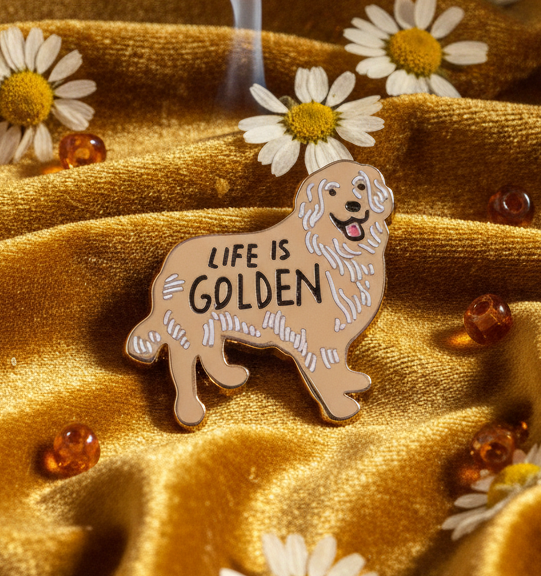 “LIFE IS GOLDEN” lion enamel pin on shimmering gold fabric with daisies