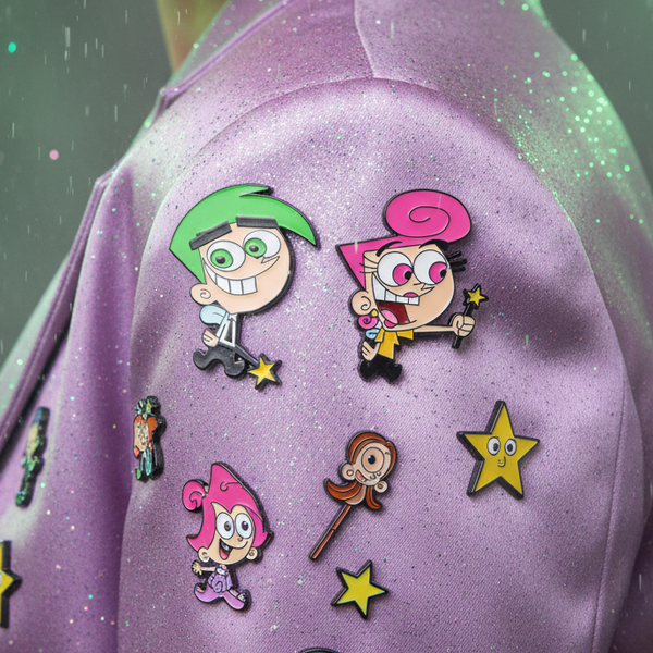 Wanda and Cosmo enamel pins with character and star designs on a purple glitter bag