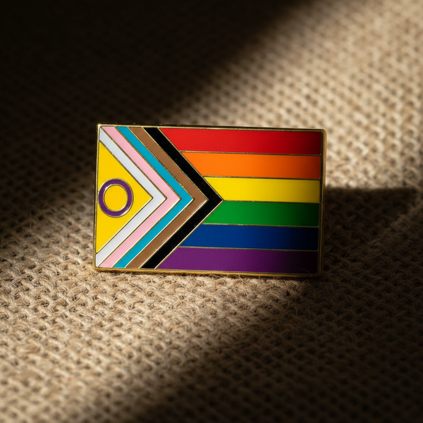 Intersex-inclusive Progress Pride enamel pin with rainbow stripes and chevron accents