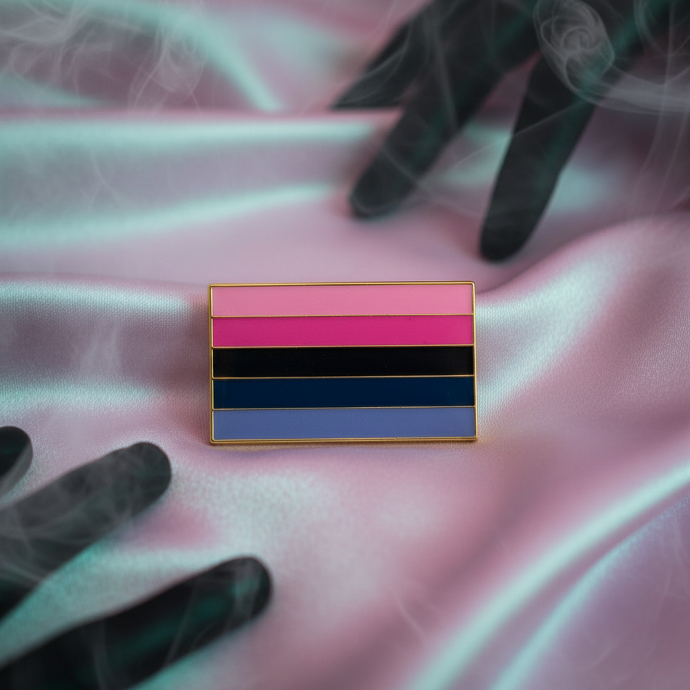 Omnisexual pride enamel pin with pink, black, blue, and lavender stripes on pink satin