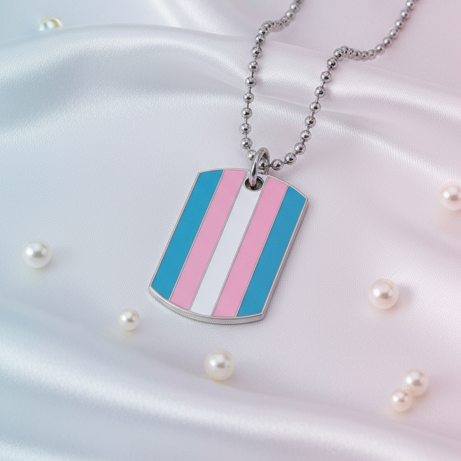 Silver dog-tag pendant with blue, pink, and white stripes on a ball chain, on satin