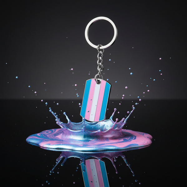 Transgender Pride Keychain with vibrant enamel stripes floats above a dynamic splash of pink and blue, symbolizing joyful self-expression, resilience, and pride.