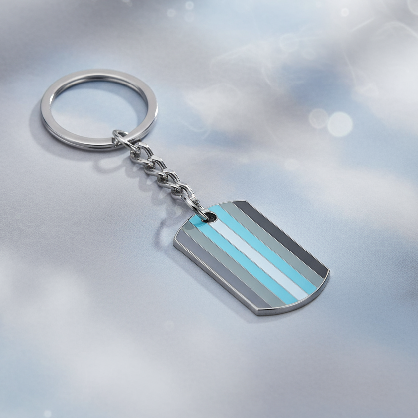 Silver keychain with a rounded dog-tag pendant in aqua, gray, and white stripes