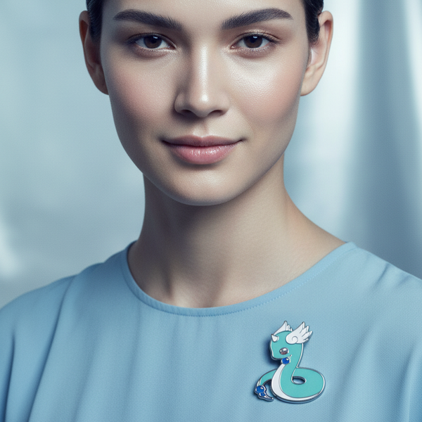 Model wearing a turquoise Dratini enamel pin with white fins on a light blue shirt