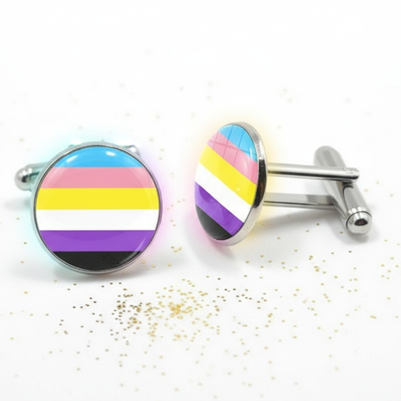 Pair of round nonbinary pride flag cufflinks on a white surface with gold specks