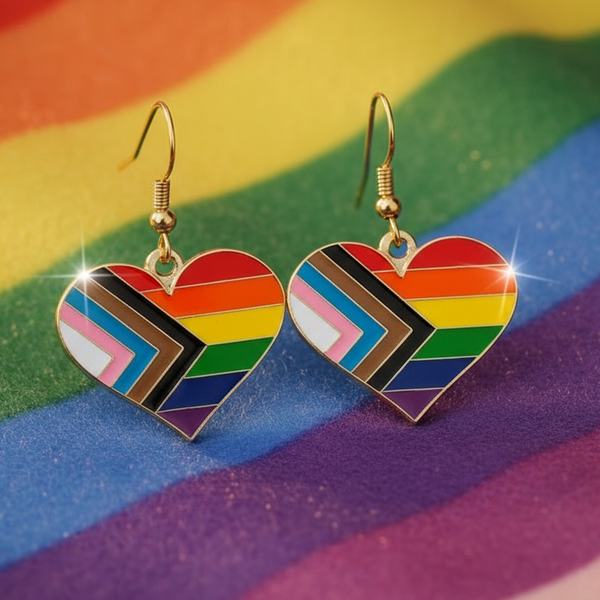 Pair of gold-trimmed heart earrings with Progress Pride flag stripes on rainbow fabric