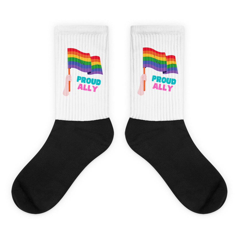 Pair of white-and-black ribbed socks with rainbow flags and “PROUD ALLY” text