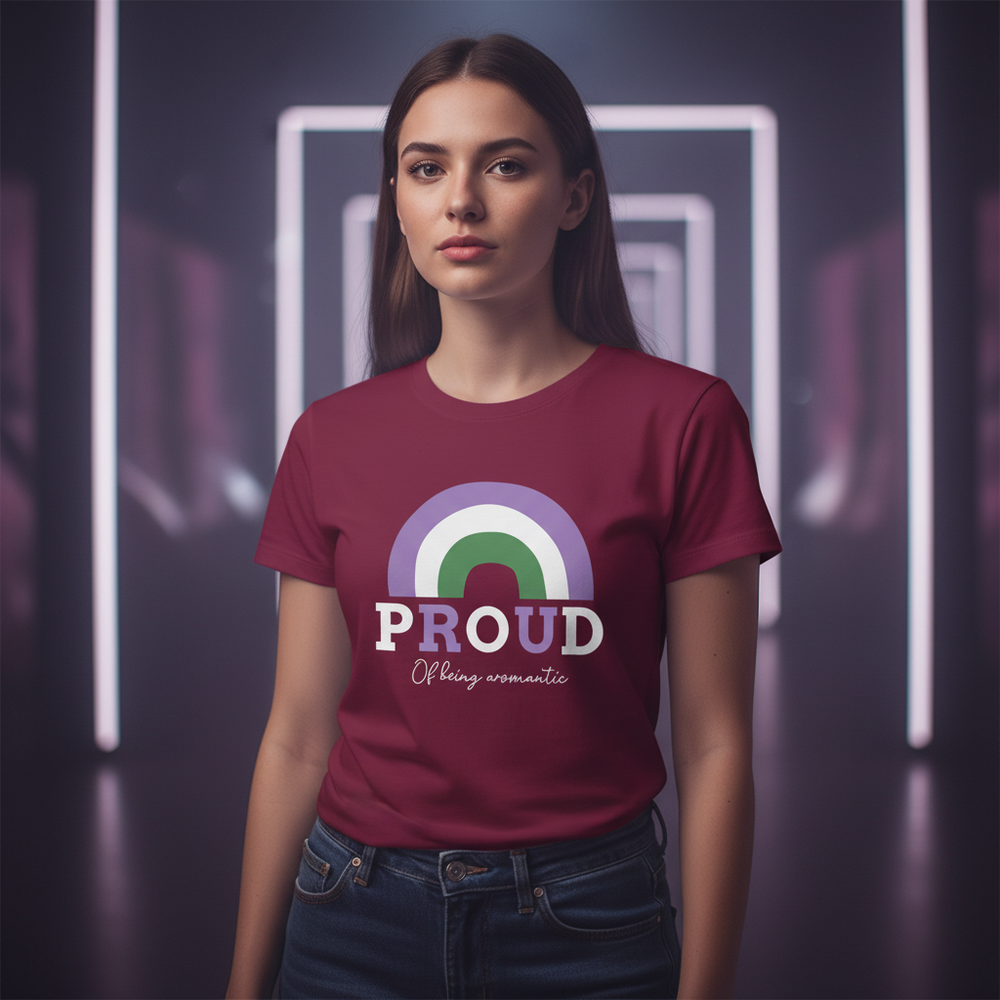 Proud Of Being Aromantic T-Shirt with a rainbow in aromantic colors, worn by a serious femme with long brown hair