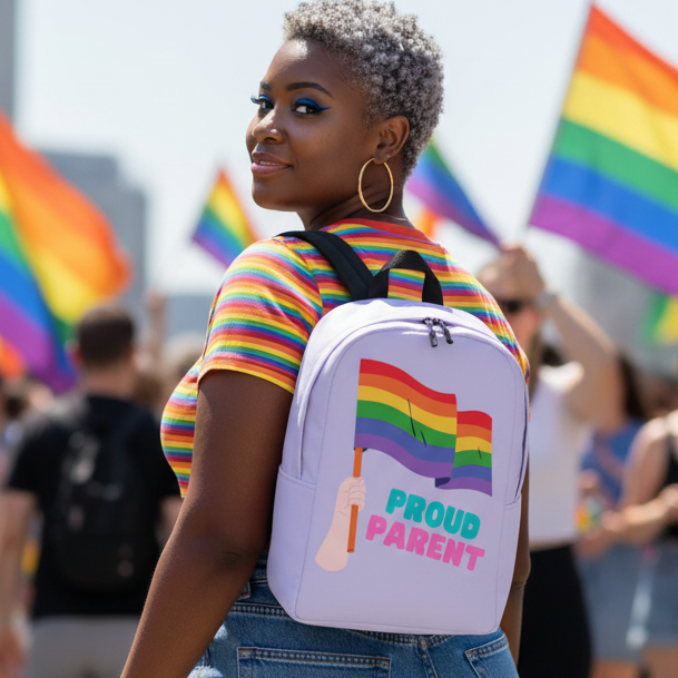 Proud Parent Minimalist Backpack with rainbow flag and "PROUD PARENT" slogan held at a pride parade