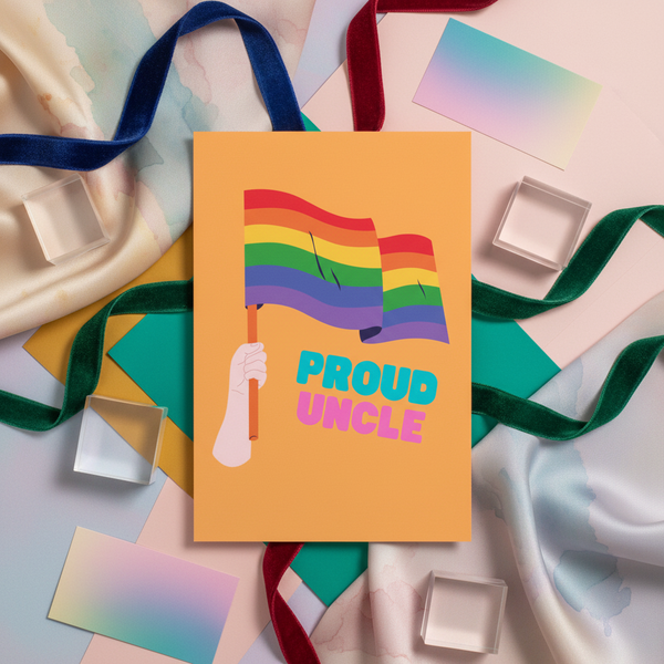 Proud Uncle postcard with a hand waving a rainbow pride flag and bold “Proud Uncle” text, shown on marble with queer decor.