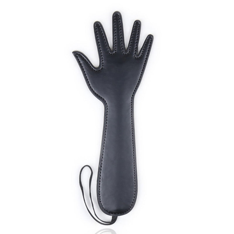 Black hand-shaped faux-leather flog laid flat on a white background