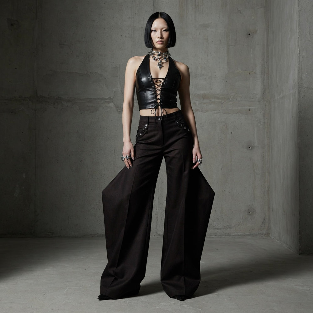 Front-facing model wearing a black leather-look lace-up halter crop top