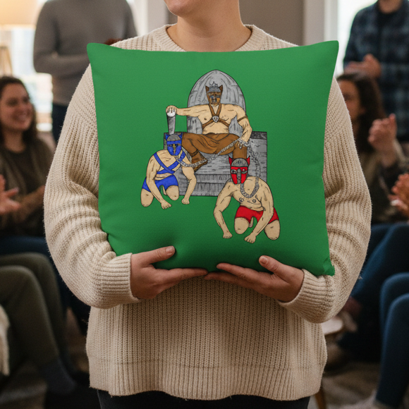 Person in a cream sweater holds a Pup Play Pillow showing three masked, muscular figures—one on a throne, two kneeling