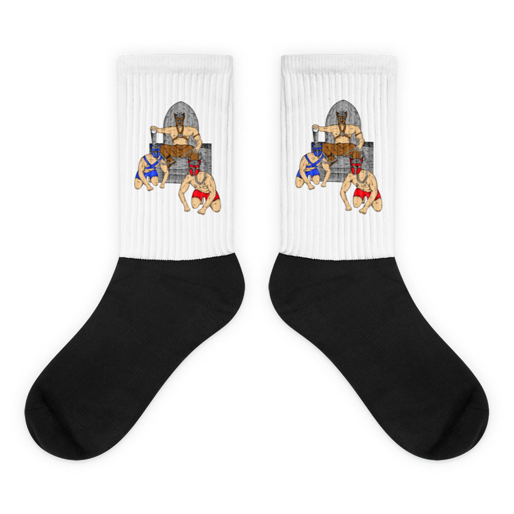 Pair of black-and-white mid-calf socks featuring three masked pup-play figures