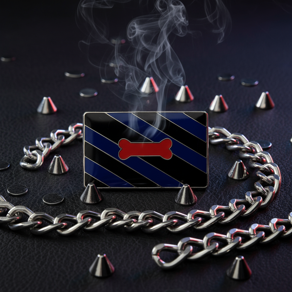 Rectangular black-and-navy striped enamel pin with a red bone, chain, studs, and smoke